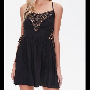 black short dress with ties on the sides and embroidery pattern
